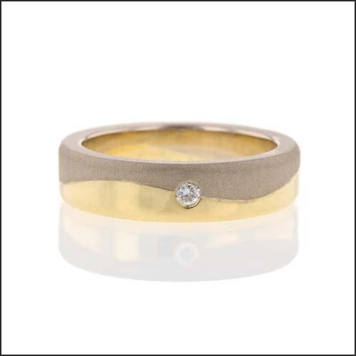 yellow and white gold wave wedding band with flush set diamond