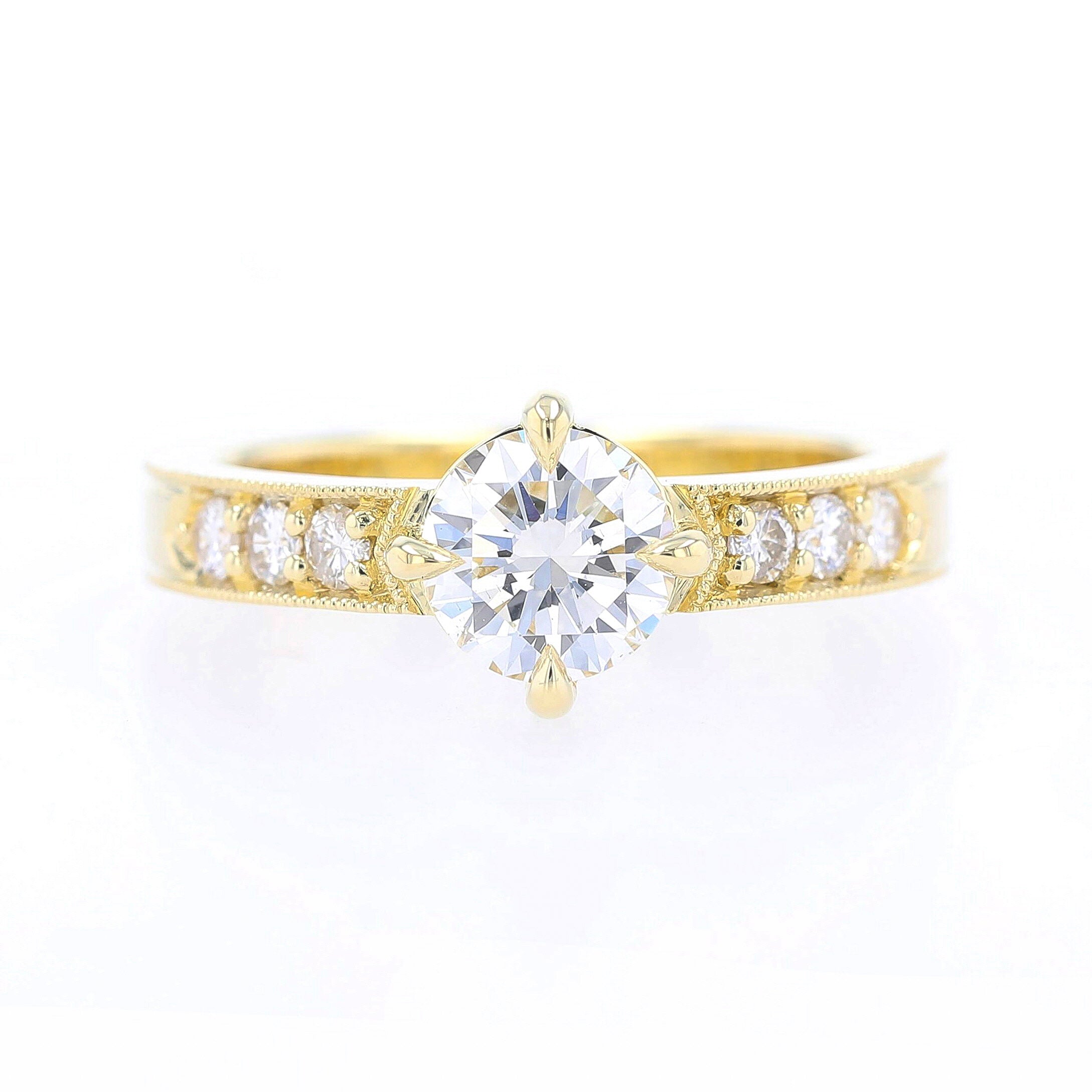 claw prong diamond engagement ring with bead set sides and milgrain