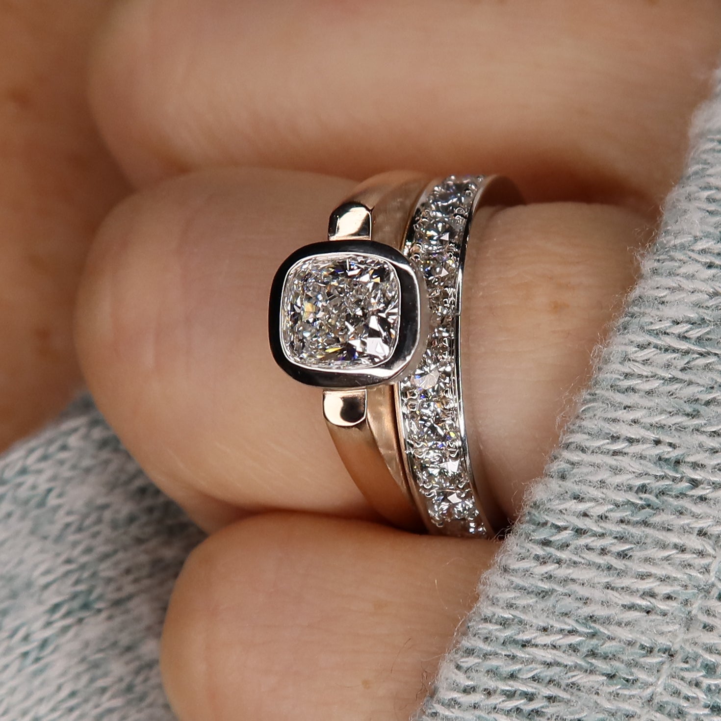 floating bezel cushion cut diamond ring with diamond band on model