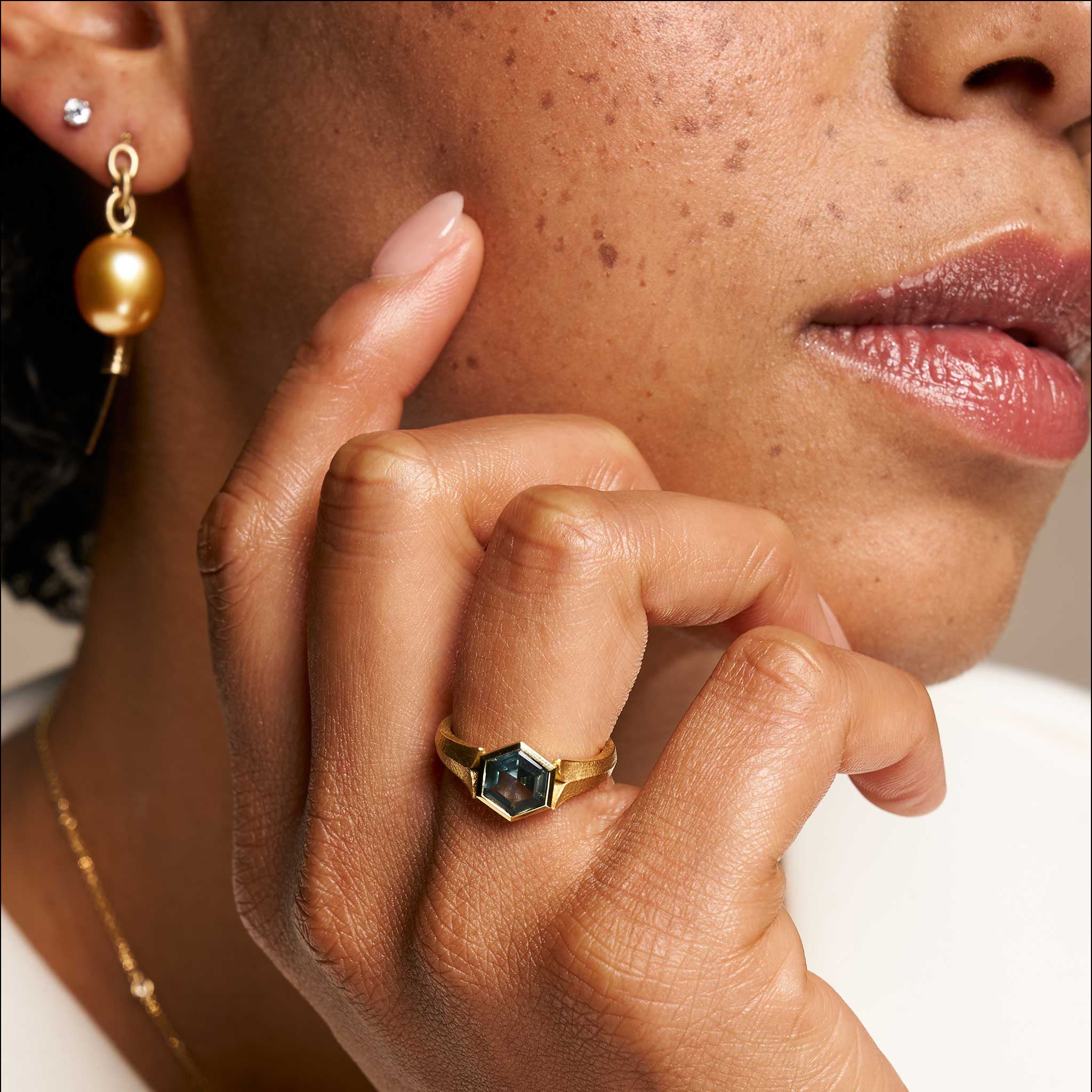 hexagonal teal montana sapphire engagement ring on model