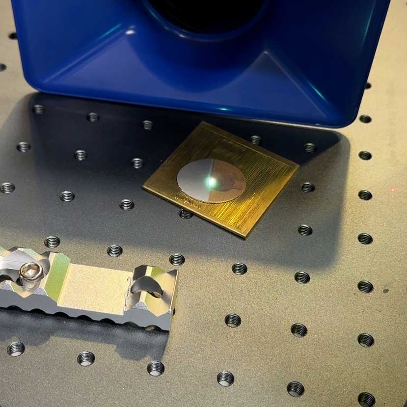 laser engraving machine engraving a photo of a dog onto sterling silver