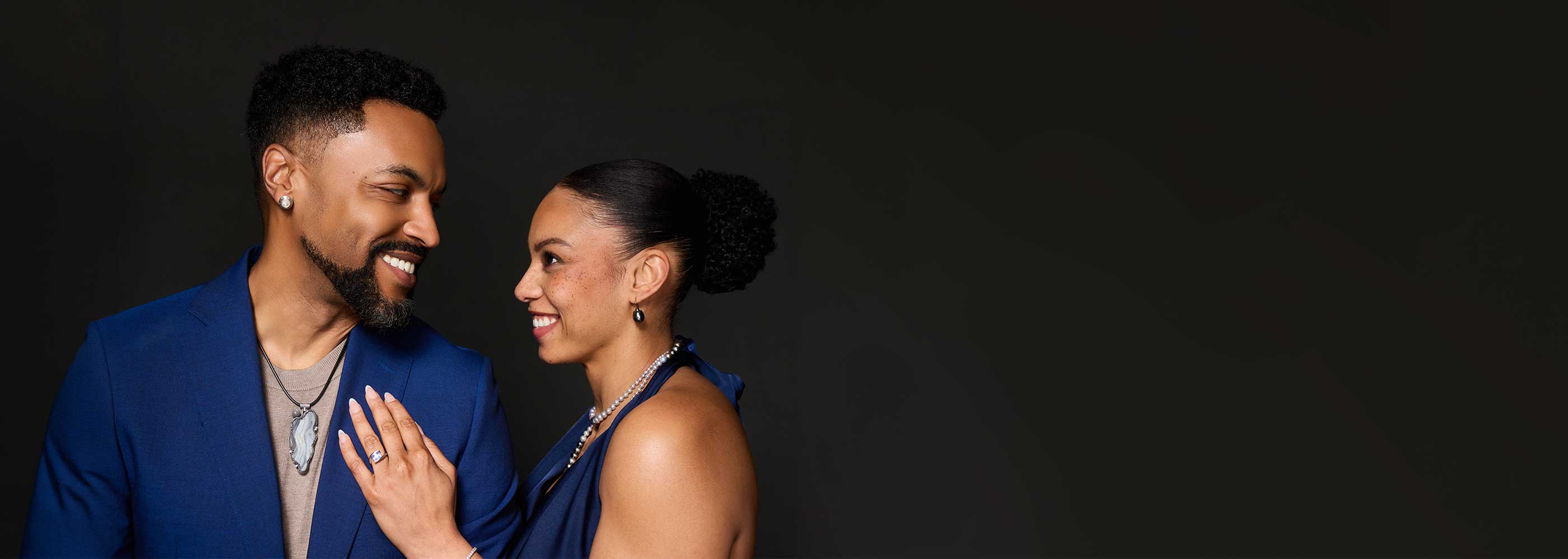 Couple wearing handcrafted Jewelsmith jewelry made on site in Durham, NC