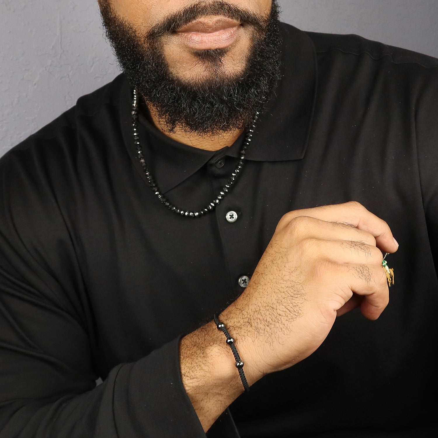 Men's jewelry model wearing black diamond bracelet and necklace in Durham, NC