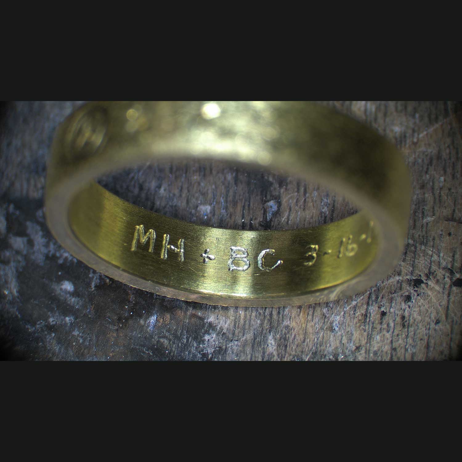 Hand inscribed initials and date on the inside of a ring band