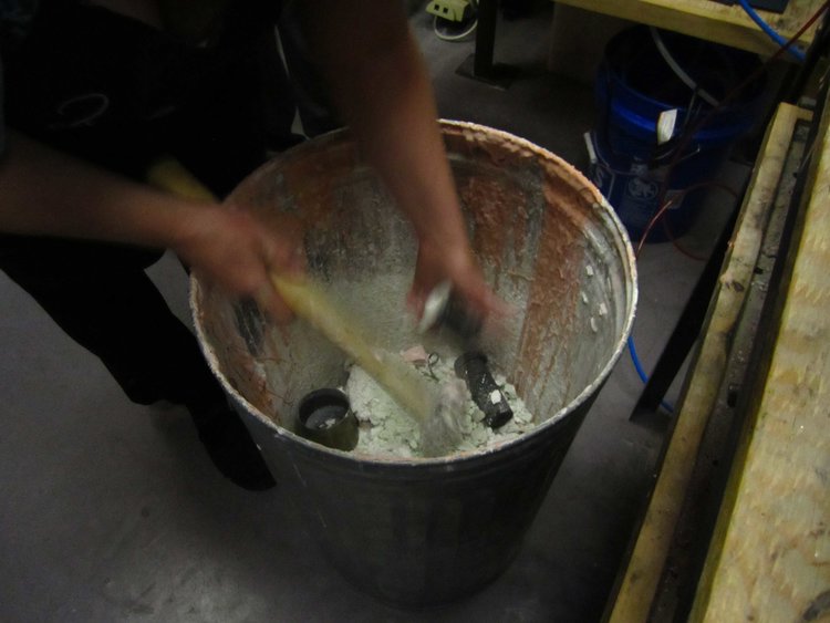 breaking casting molds to remove castings