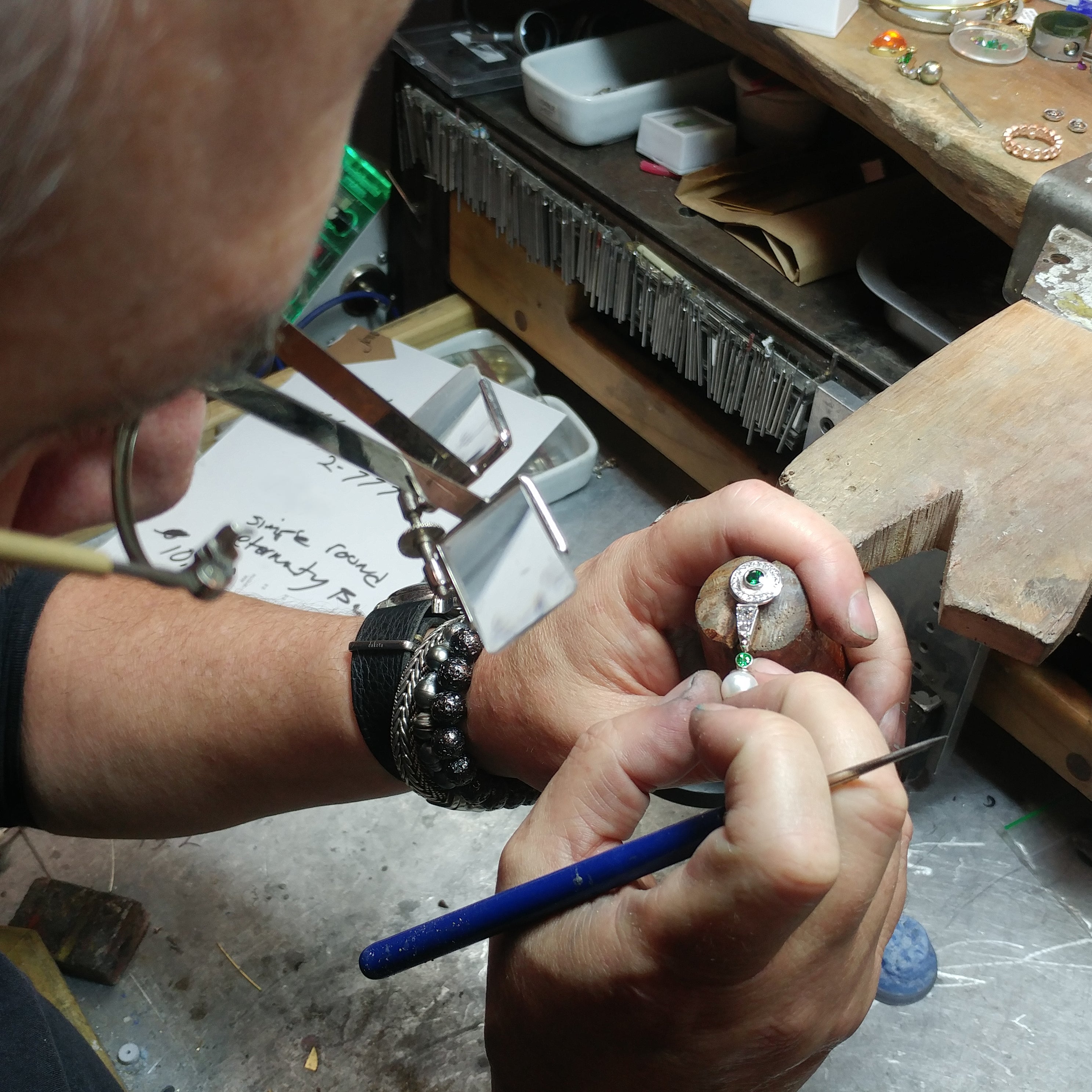Goldsmith Phil Dismuke inspects earring he just created in Durham, NC