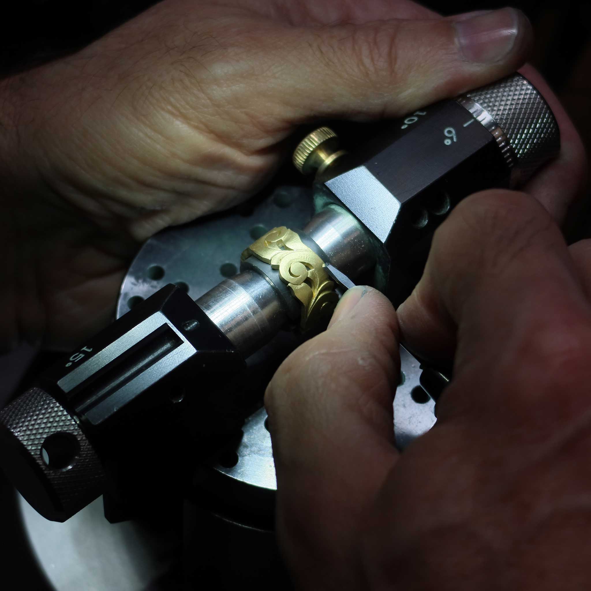 Goldsmith handcrafting scroll ring