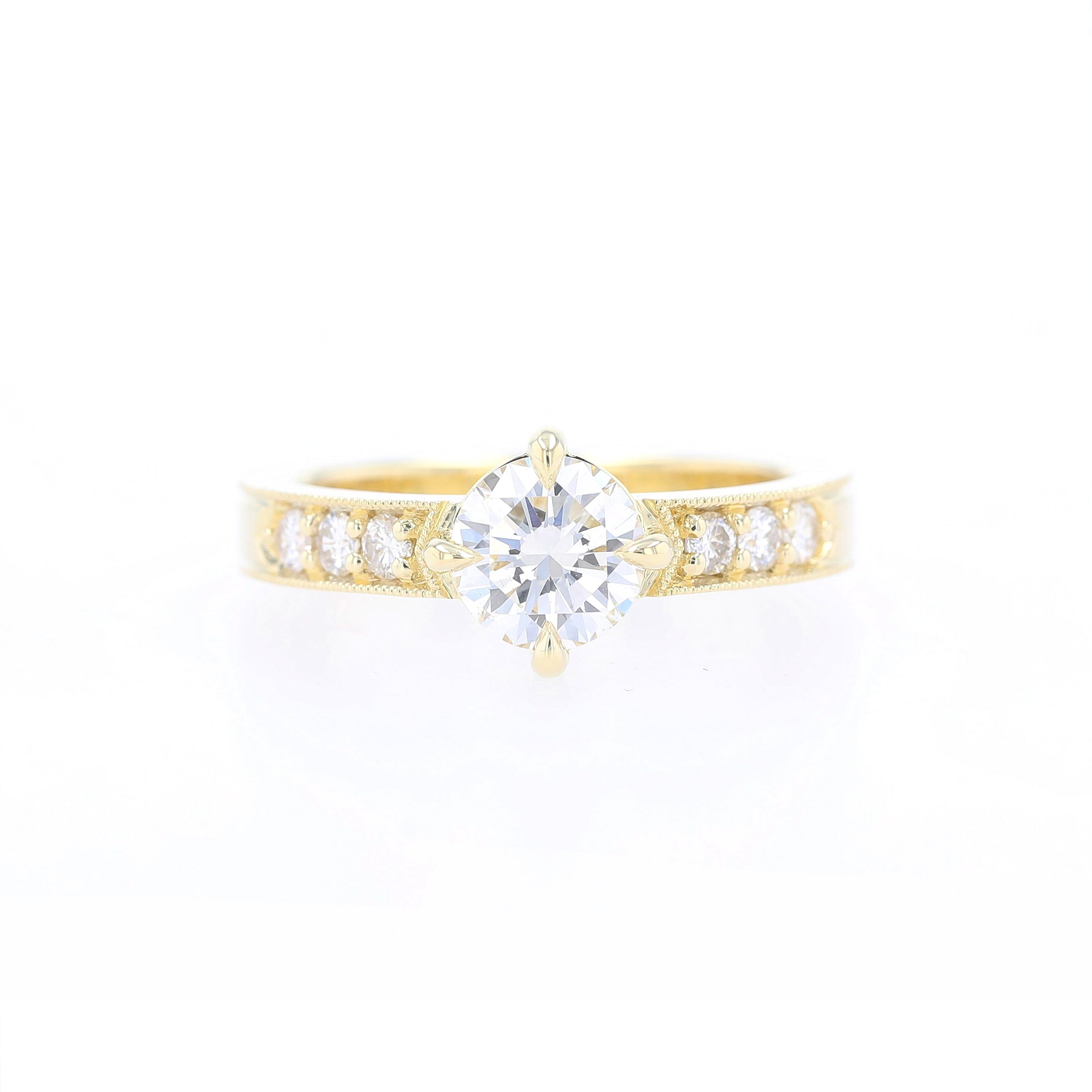 compass point oriented prong set round diamond engagement ring with bead set sides and milgrain details