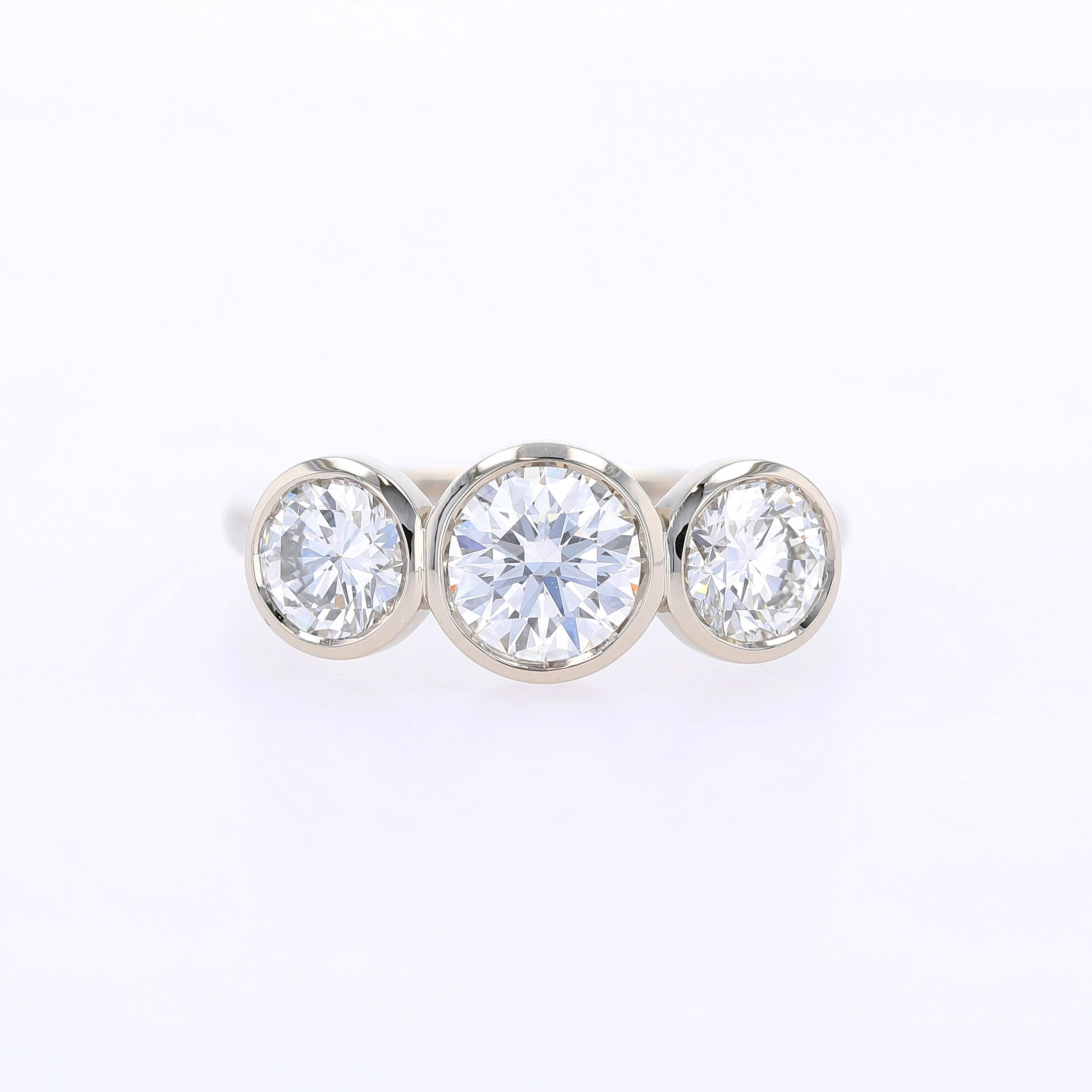 three stone bezel set diamond engagement ring 