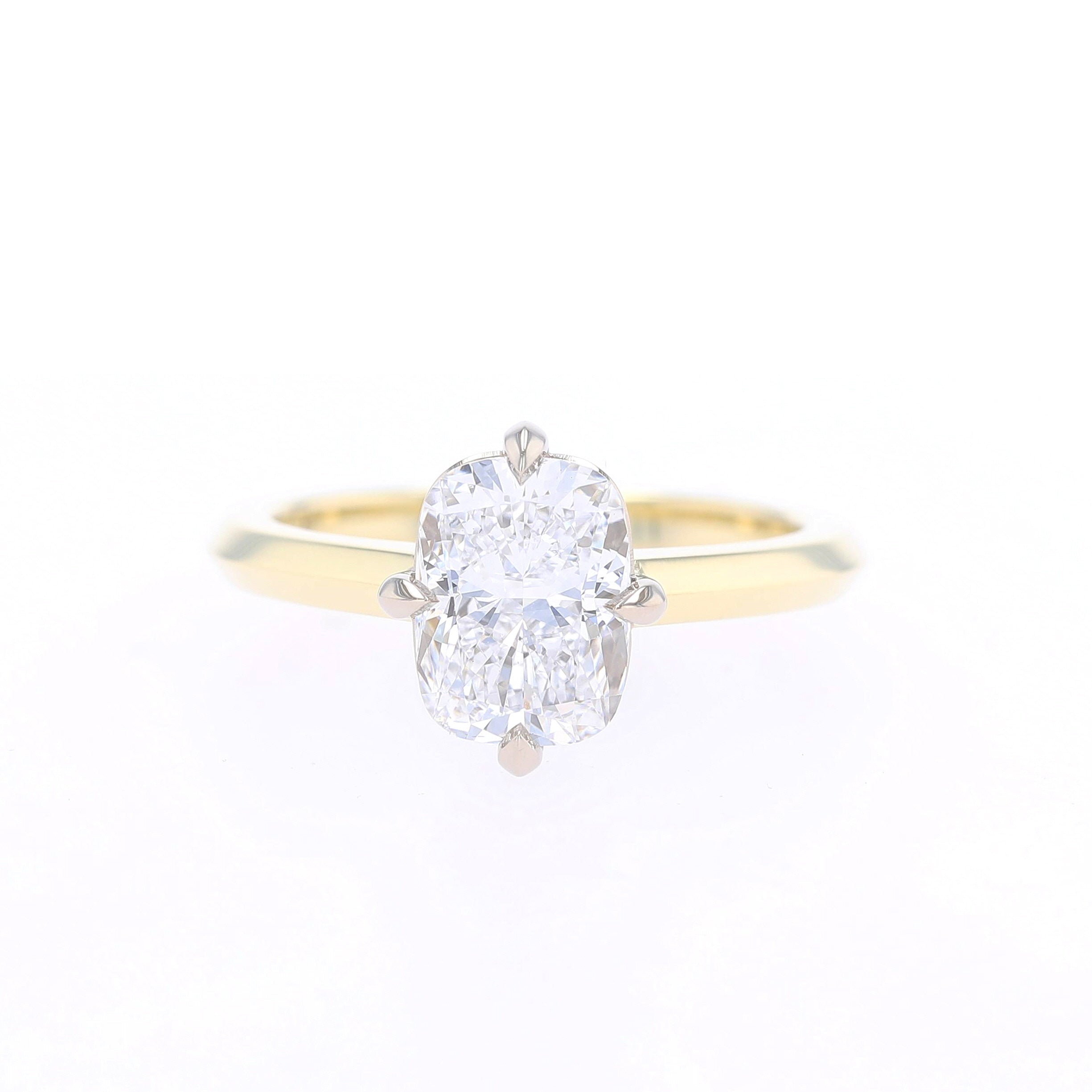 cushion cut diamond set in compass point oriented prongs engagement ring