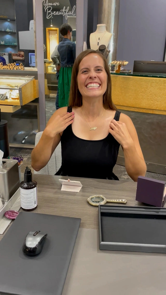 Jewelsmith client showing off her custom North Carolina pendant