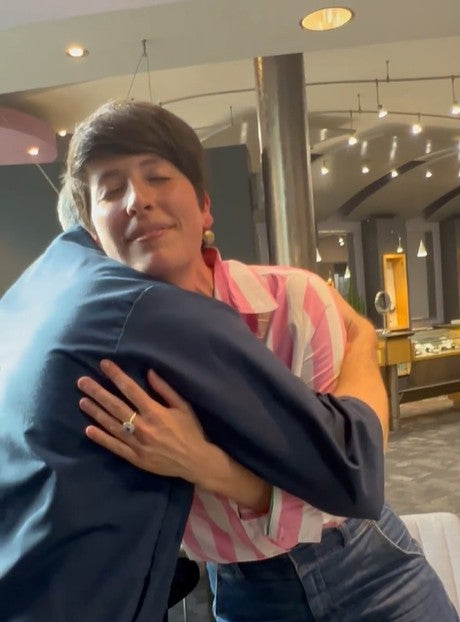 Jewelsmith client hugging goldsmith Patrick King in gratitude for her custom Jewelsmith earrings