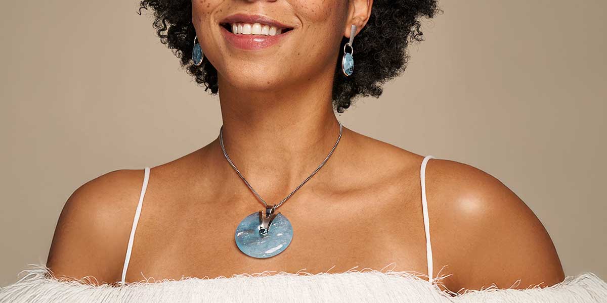 aquamarine pendant on model representing bold jewelry