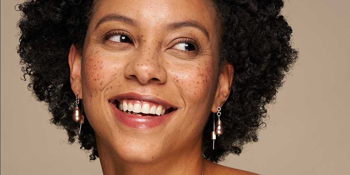 model wearing pearl threader earrings to represent gift ideas under $2000