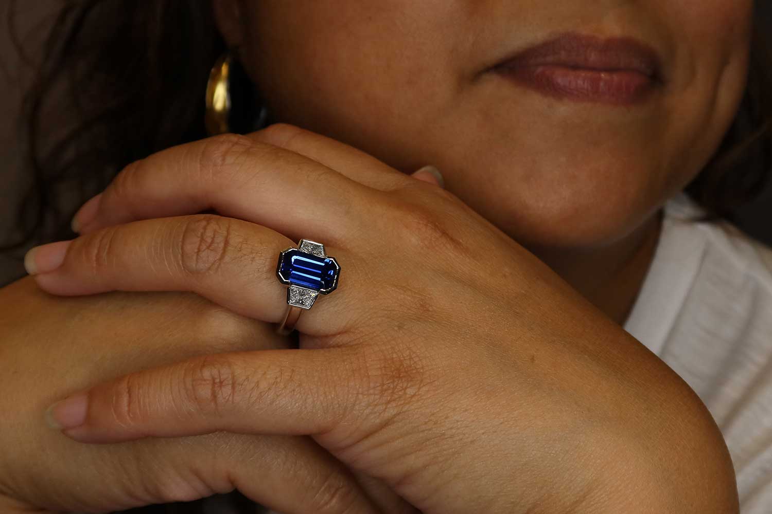 emerald cut sapphire diamond ring on model